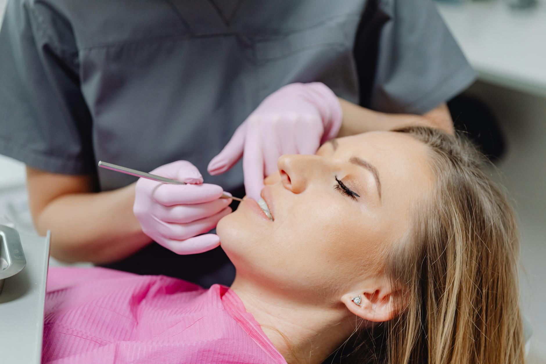 dentist applying composite bonding material to patient tooth